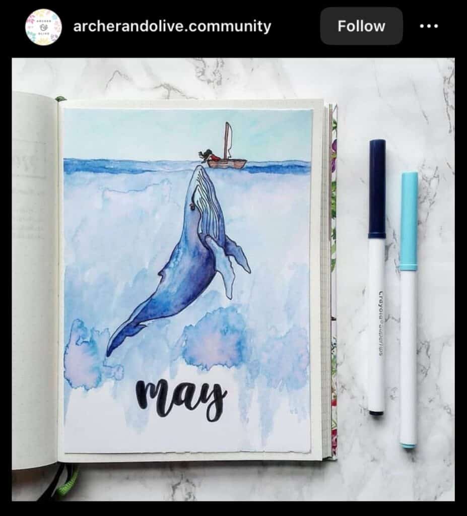 blue bullet journal spread with a whale painting